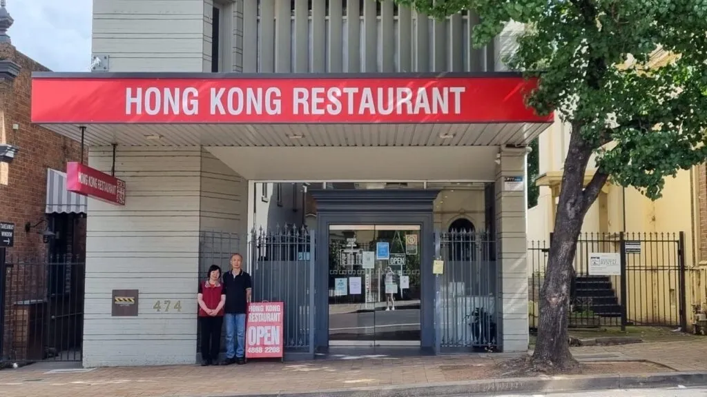 Winnie and Fai, co-owners of Hong Kong Restaurant, smiling together in the restaurant